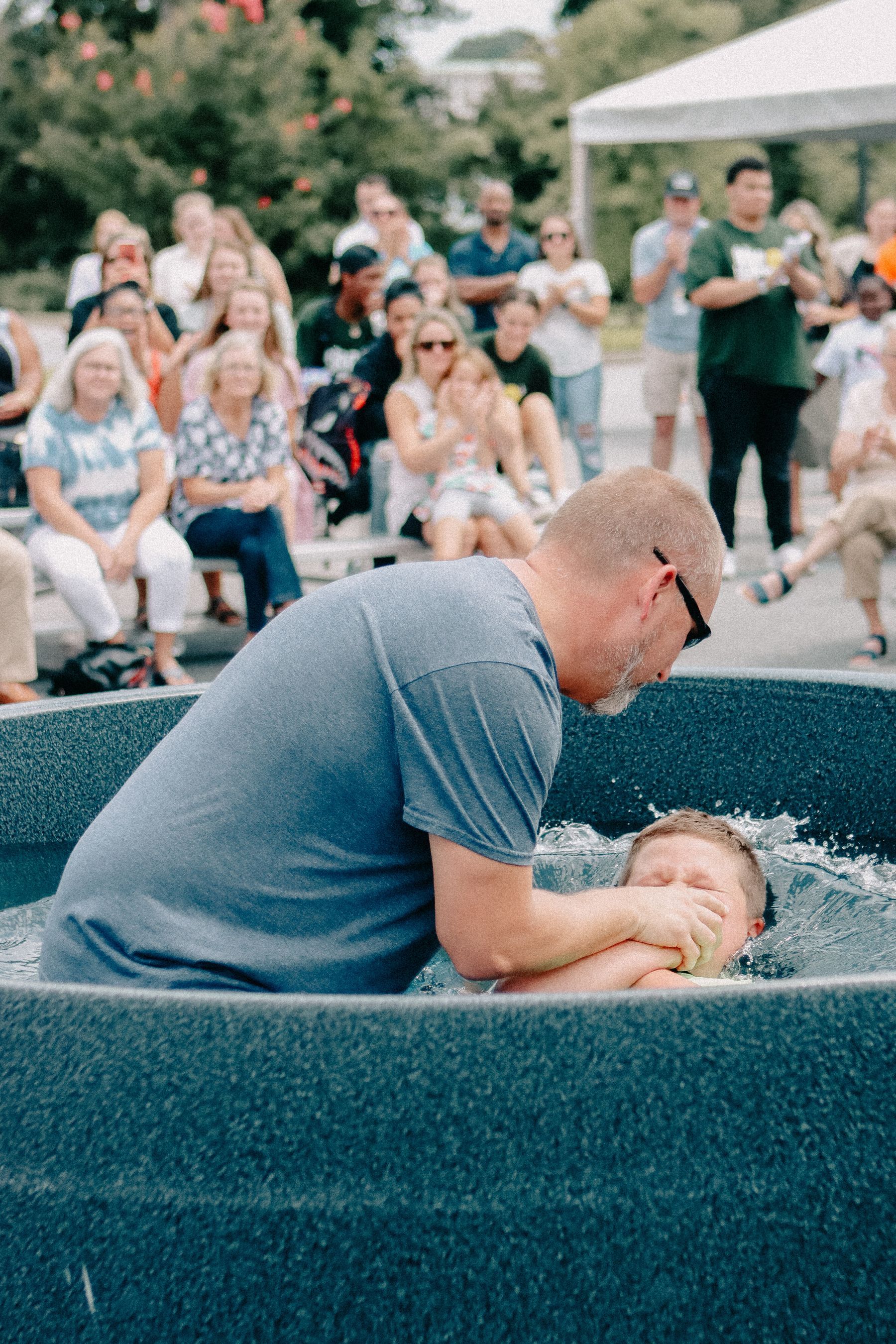Friends cheering at a baptism