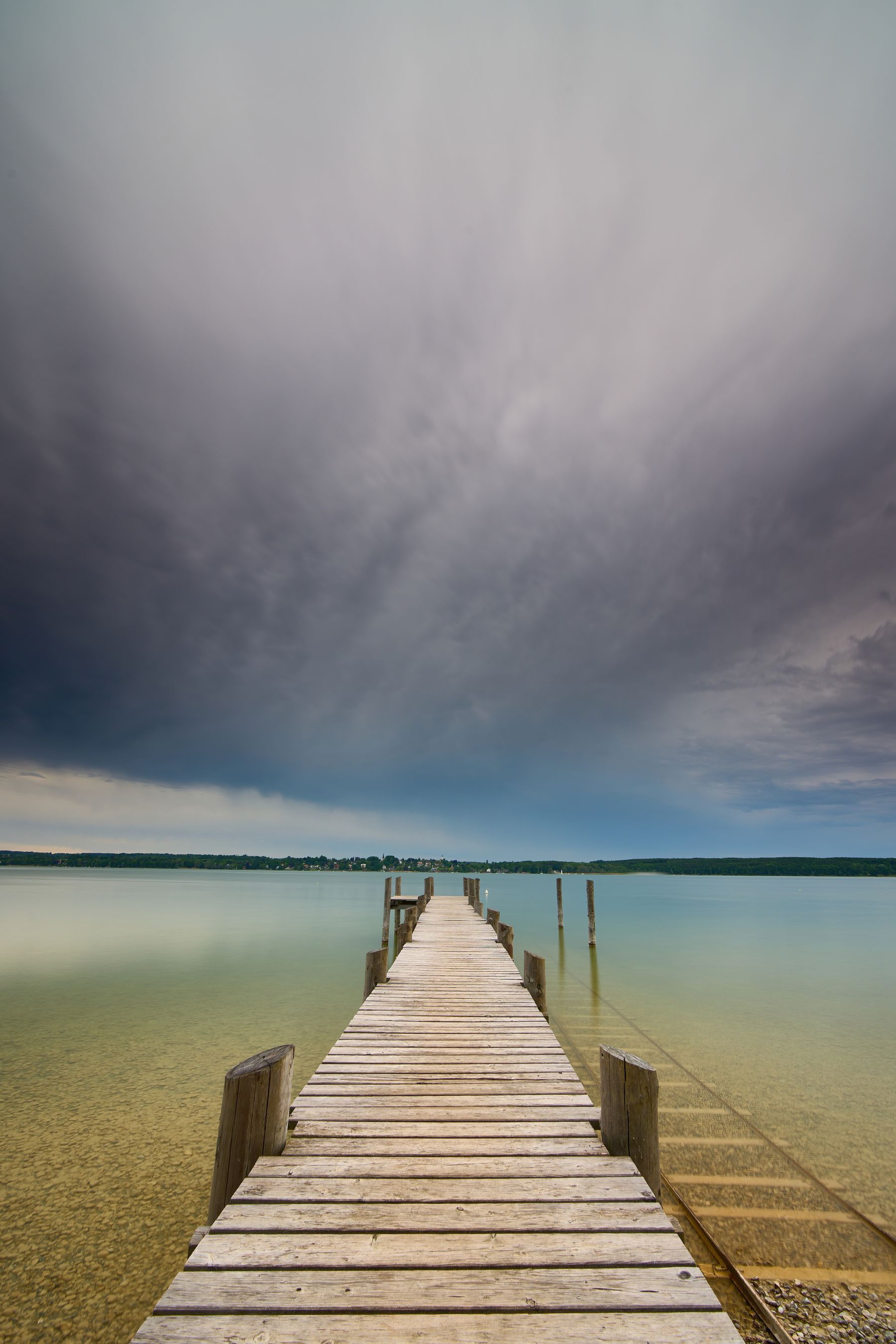 A long pier over still water